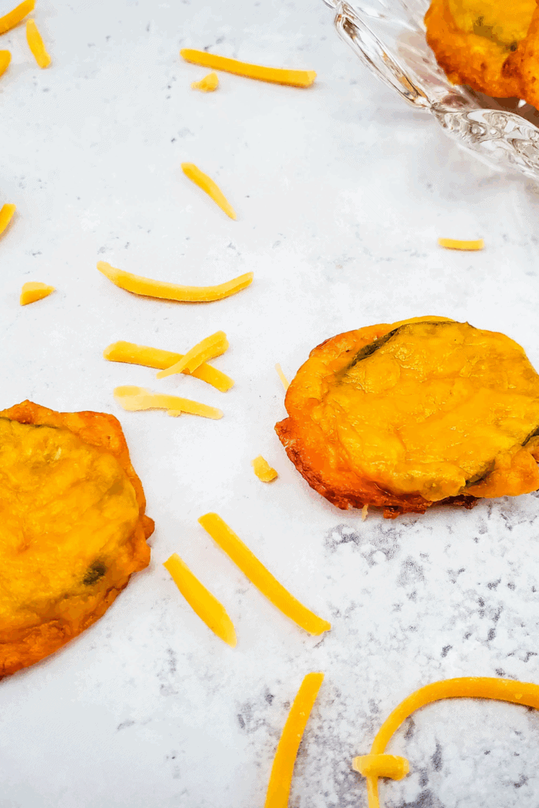 Crispy golden air fryer cheese pickles on a plate, ready to serve