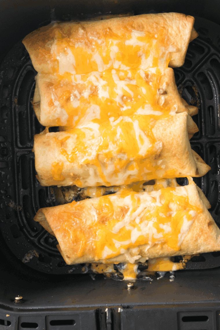 Air fryer chicken chimichangas on a plate, golden and crispy, ready to serve.