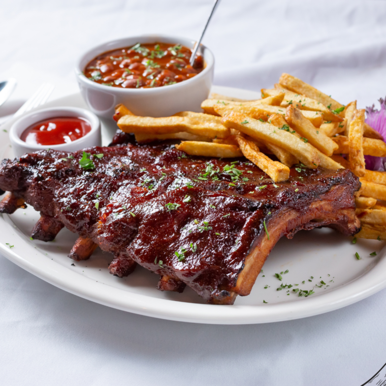 BBQ Baby Back Ribs with a charred glaze after a quick broil, ready for serving.