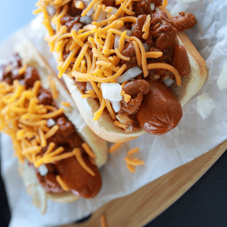 Cincinnati chili over spaghetti topped with cheddar and diced onions, served Skyline 4-way style 