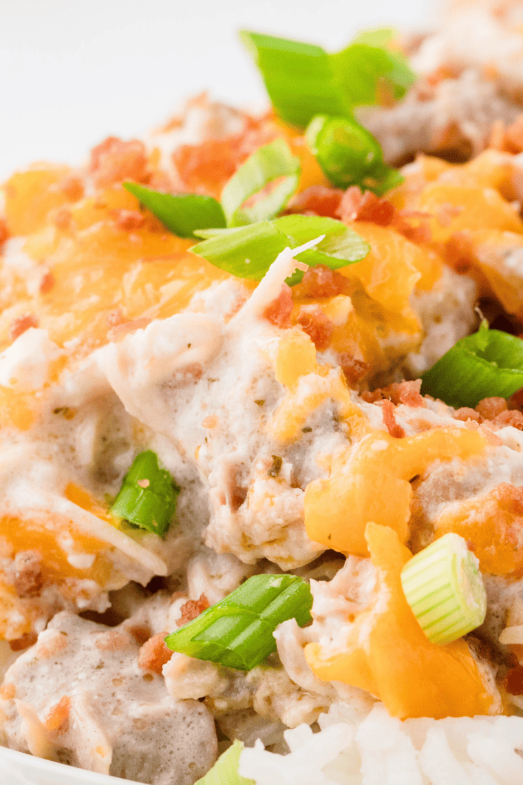 Instant Pot crack chicken topped with crumbled bacon and sliced green onions