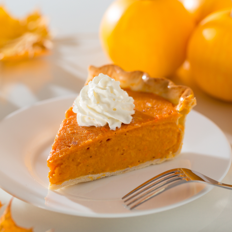 Instant Pot pumpkin pie topped with whipped cream with a text overlay reading Instant Pot Pumpkin Pie