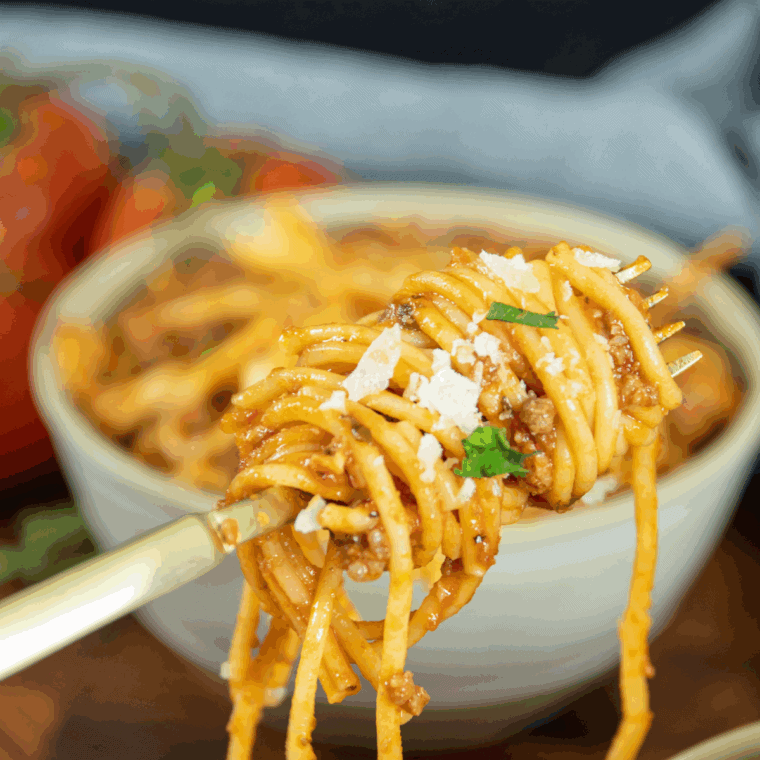 A bowl of rich Instant Pot Rao’s Marinara Copycat Sauce with a spoon, ready to serve with pasta, pizza, or garlic bread.