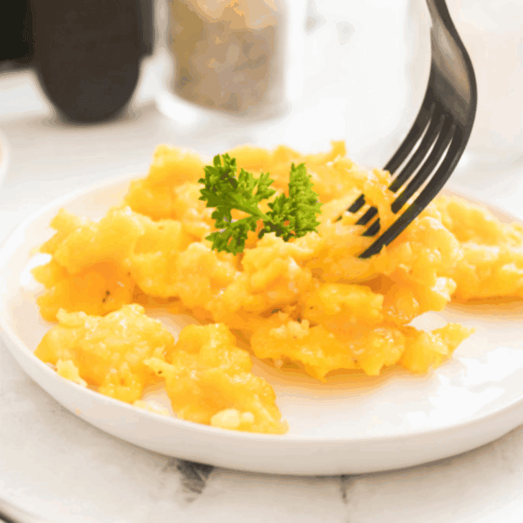Fluffy scrambled eggs cooked in an Instant Pot for a quick breakfast.