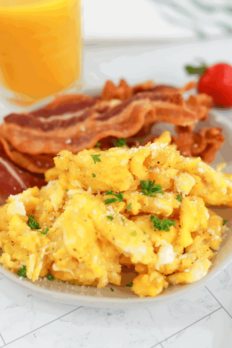Creamy scrambled eggs cooking in an Instant Pot on sauté mode.
