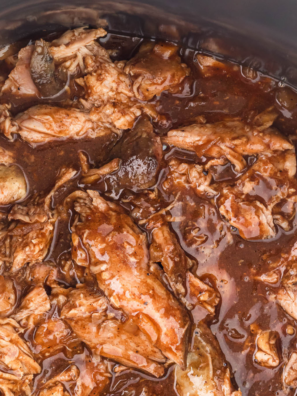 Shredding slow cooker chicken with two forks for copycat Mission BBQ pulled chicken