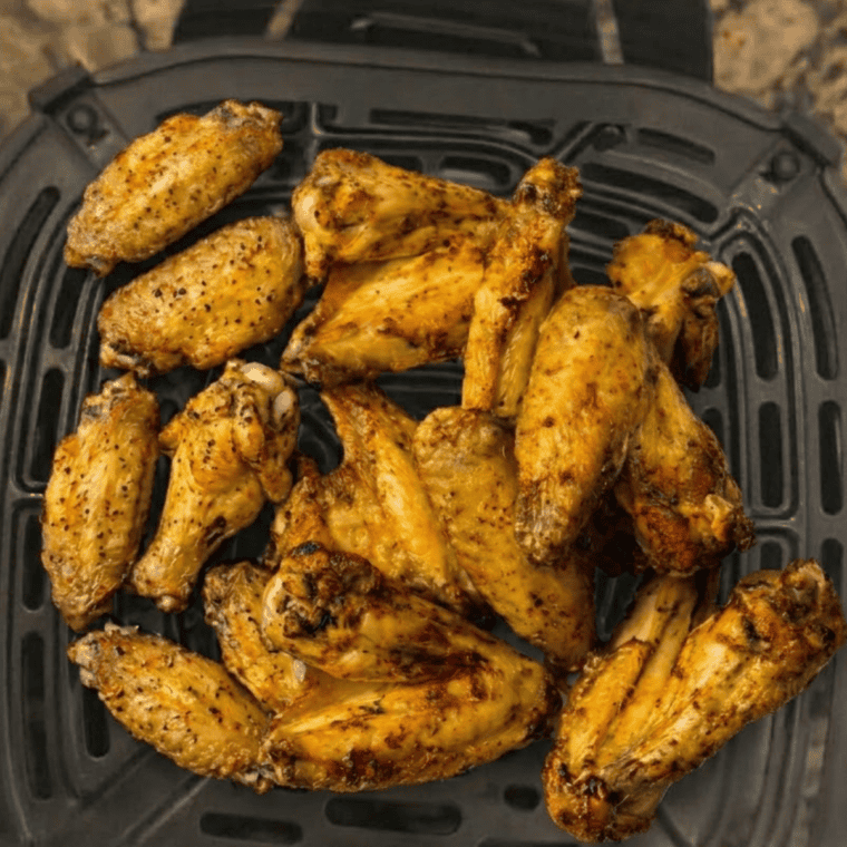 Cooked Ninja Crispi chicken wings tossed in sauce and ready to serve