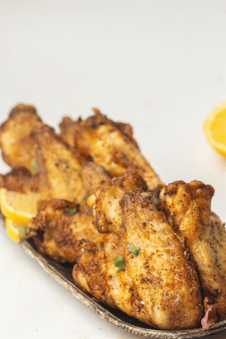 Cooked Ninja Crispi chicken wings tossed in sauce and ready to serve