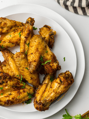 Ninja Crispi chicken wings tossed in buffalo sauce on a serving plate
