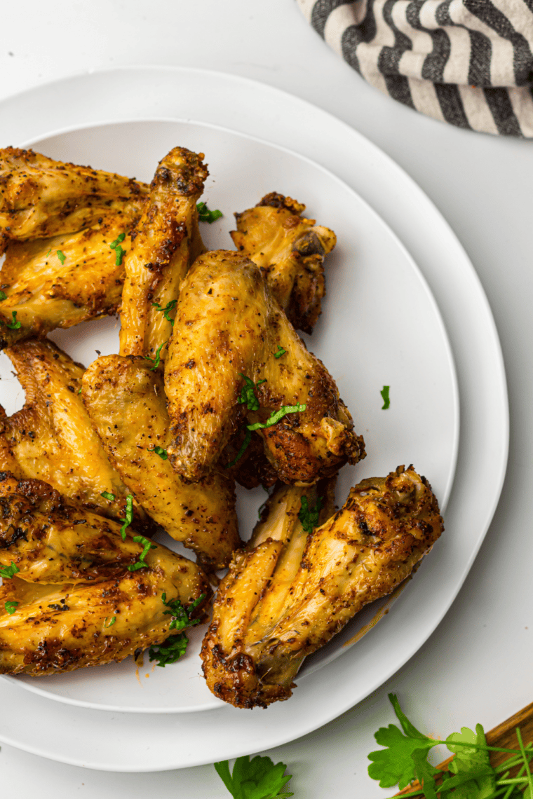 Ninja Crispi chicken wings tossed in buffalo sauce on a serving plate