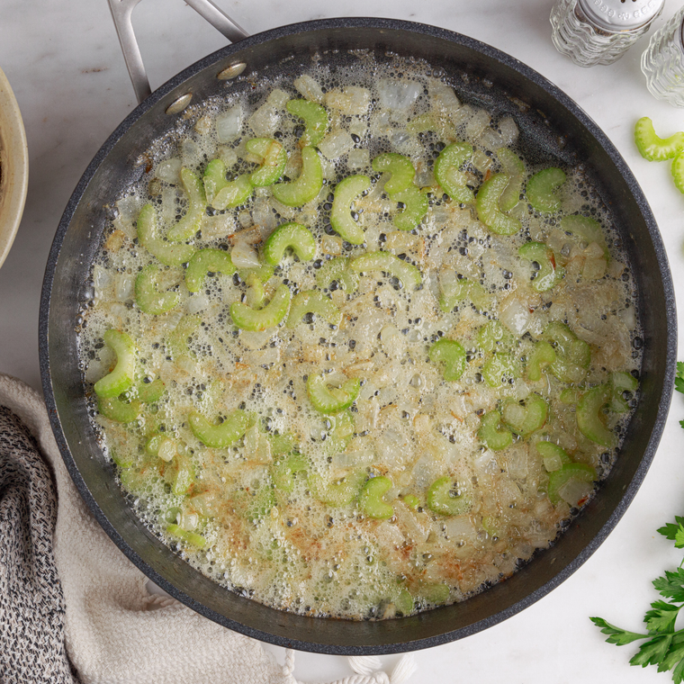 Diced onion, carrot and celery softening in melted butter in a Dutch oven with fresh thyme