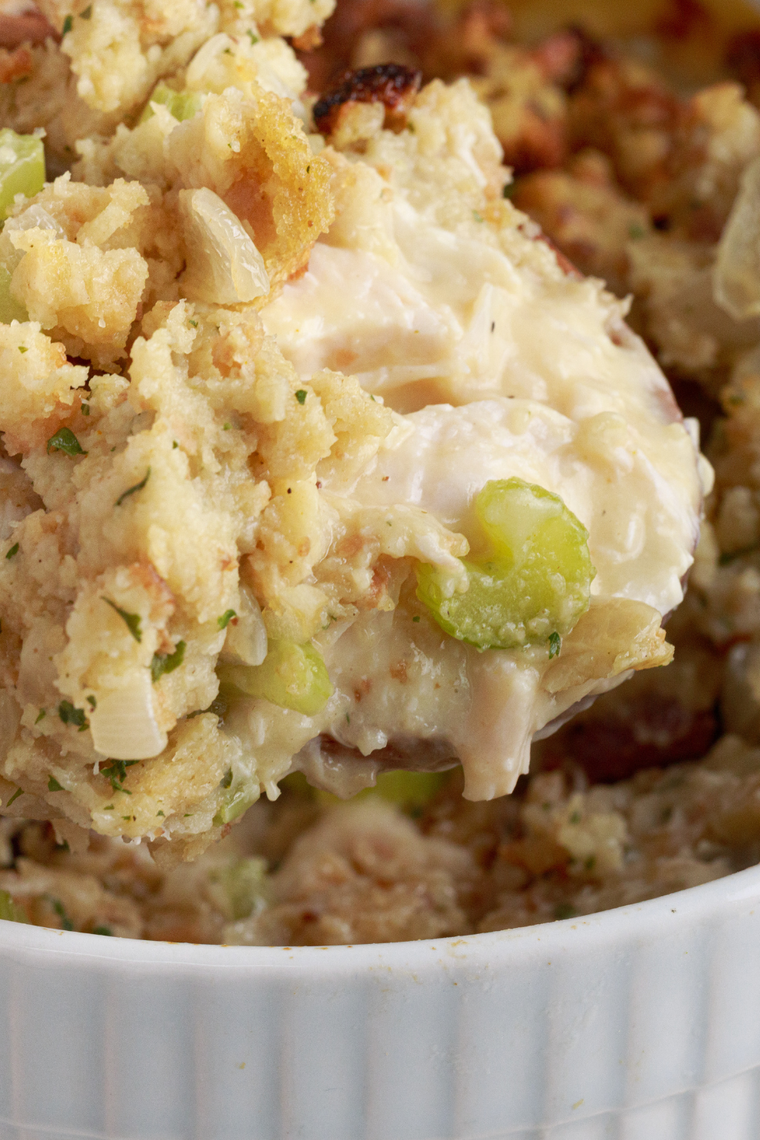 Baked Pioneer Woman chicken stuffing casserole with creamy chicken, peas and carrots under a buttery stuffing crust