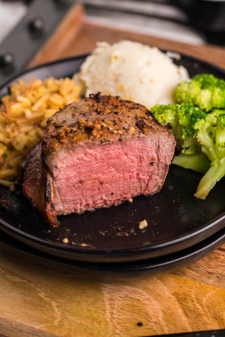 Close-up of cooked beef tenderloin with a browned crust and tender pink center