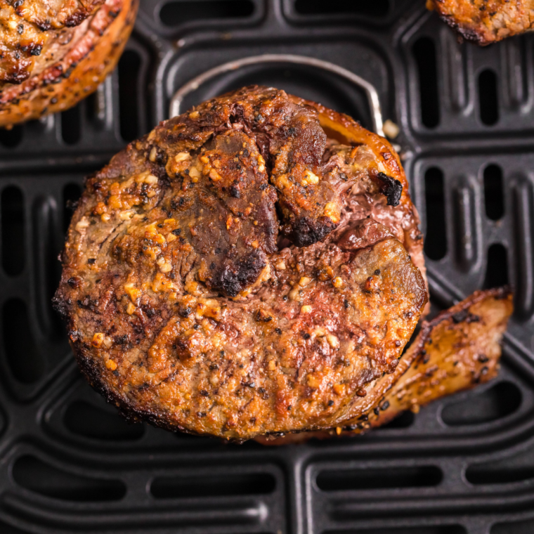 Air fryer basket heating up empty to 400&deg;F to create a hot cooking surface for a proper sear.