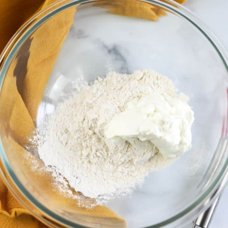  Mixing self-rising flour and Greek yogurt to form the bagel dough