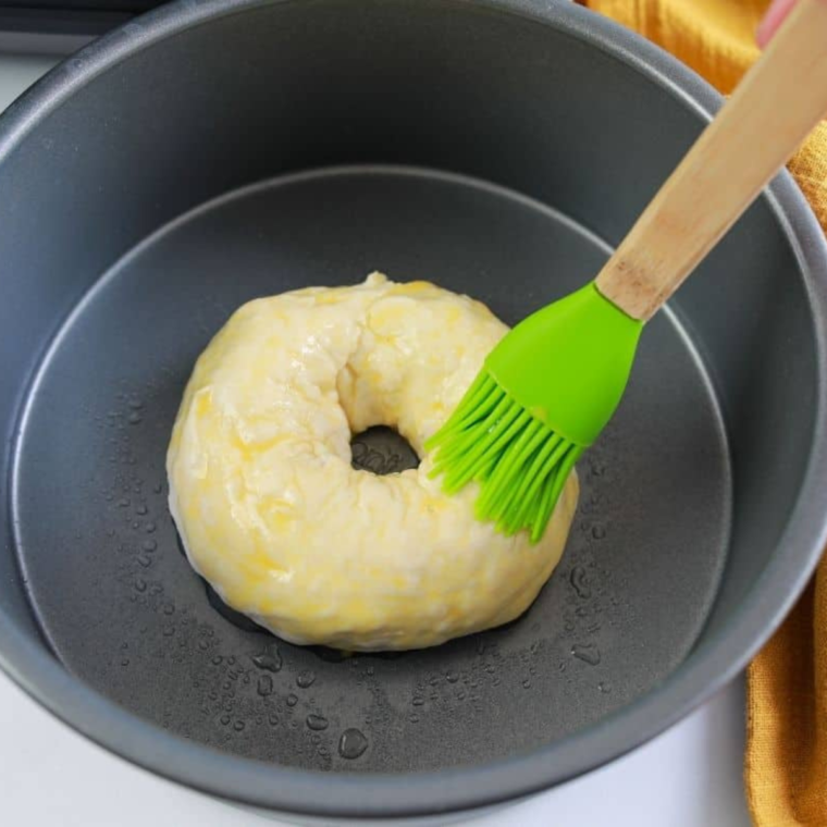  Applying a generous layer of everything bagel seasoning on top of the dough