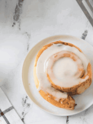 Golden, fluffy Pillsbury cinnamon rolls cooked in the air fryer and drizzled with icing.