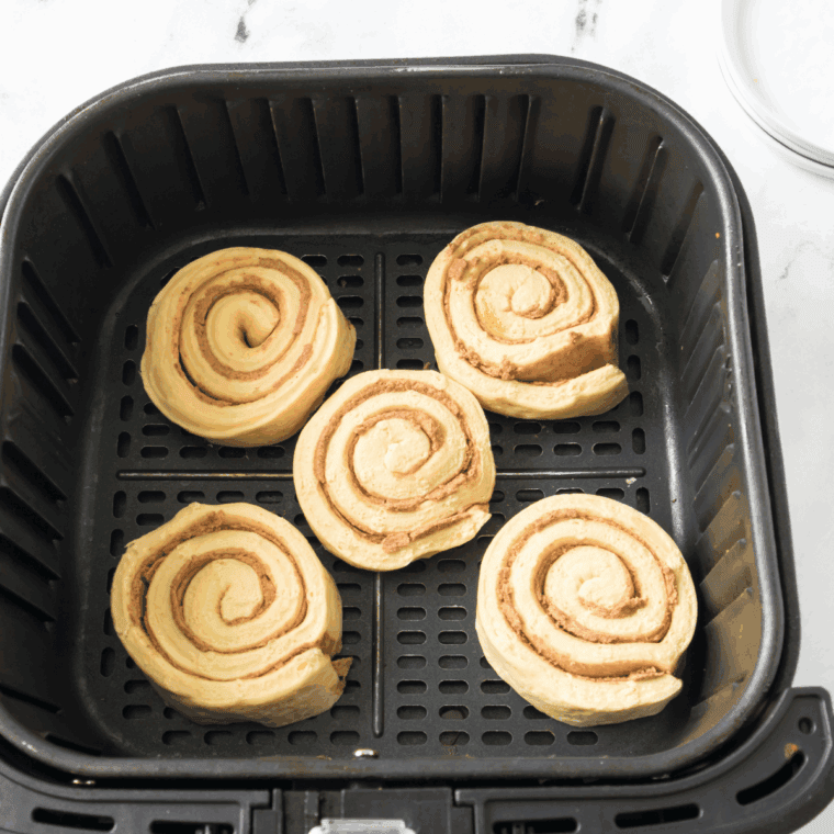 Place Pillsbury Cinnamon Rolls in the air fryer basket.