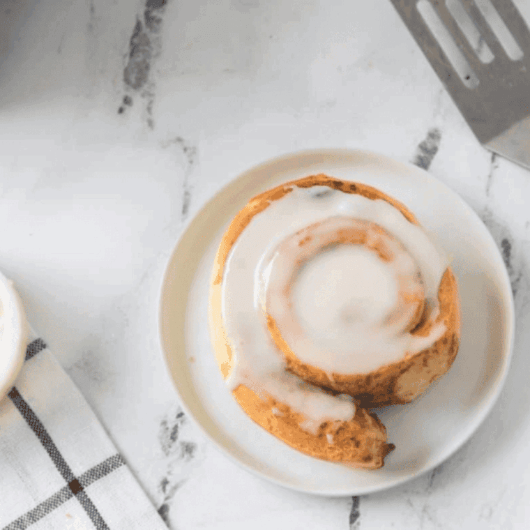 Golden, fluffy Pillsbury cinnamon rolls cooked in the air fryer and drizzled with icing.