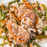 Juicy Air Fryer Teriyaki Pork Chops served on a plate with sesame seeds and green onions