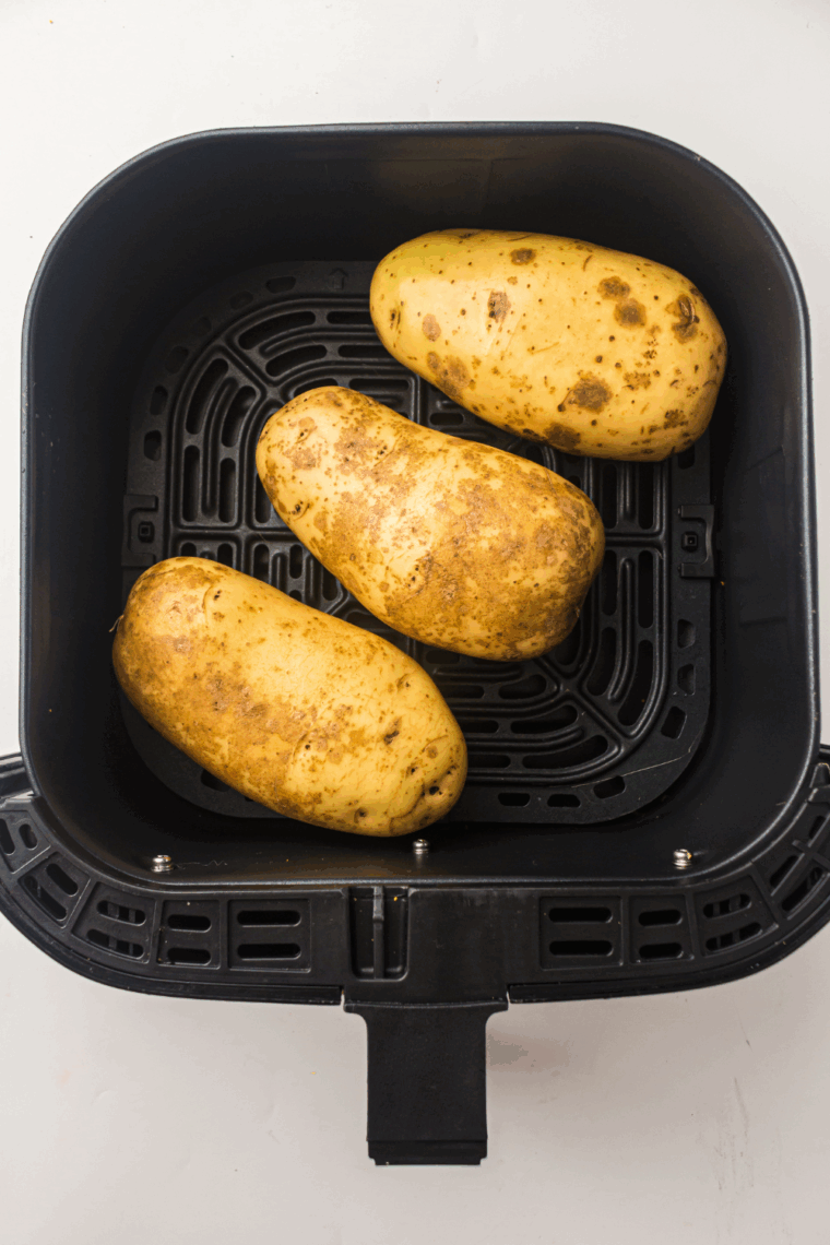 Place the baked potato into the air fryer basket.