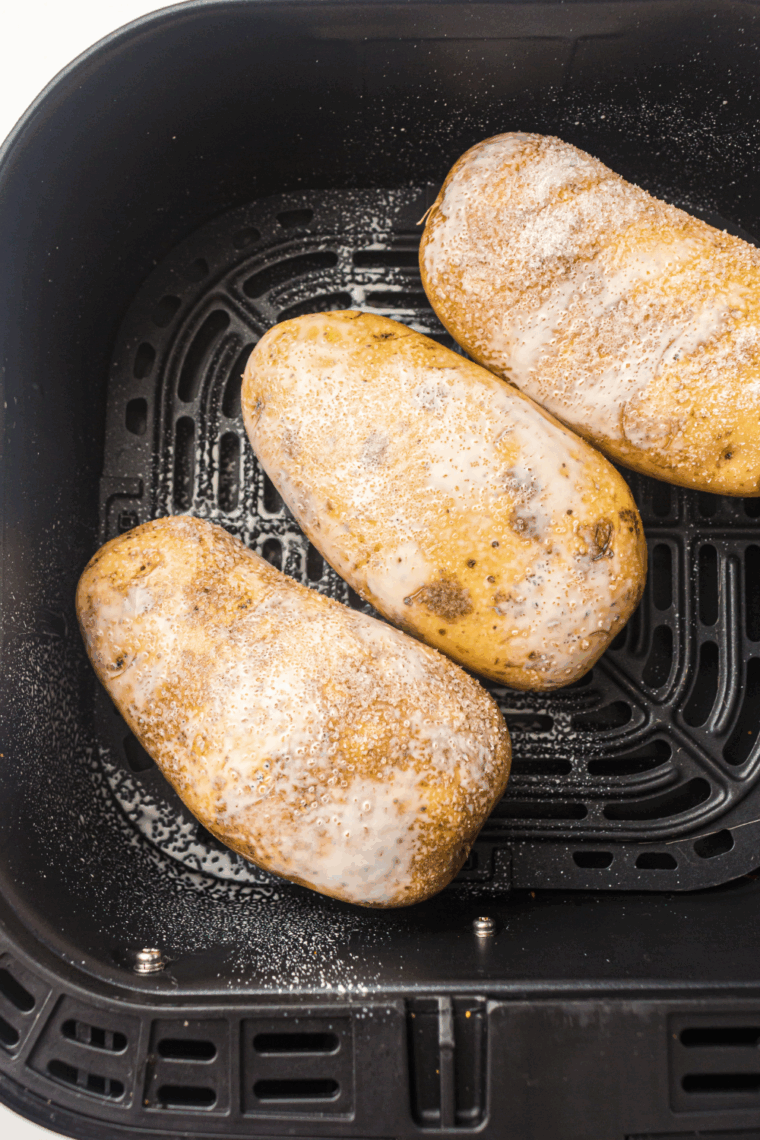 Place seasonings onto the baked potatoes.