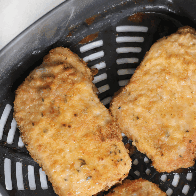 Cooked Cracker Barrel Country Fried Pork Chops in the air fryer basket.