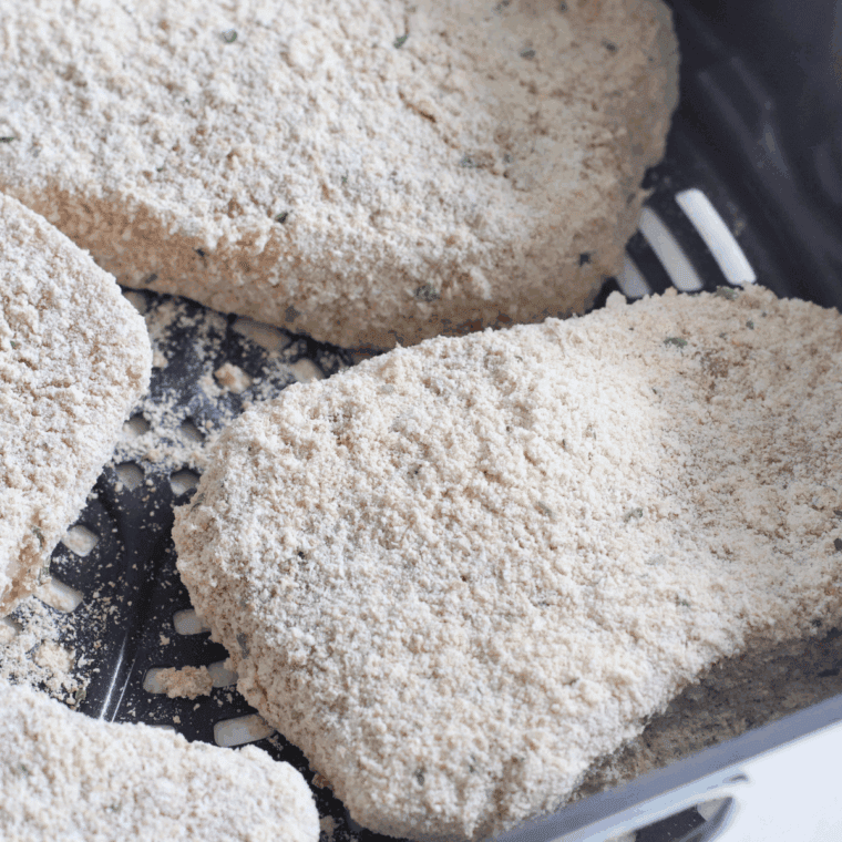 Preheating air fryer and cooking breaded pork chops to crispy perfection.
