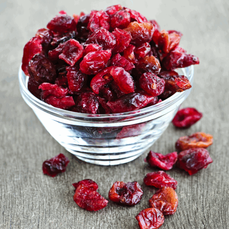 Ingredients needed for Easy Cranberry Pecan Cheese Ball on kitchen table.