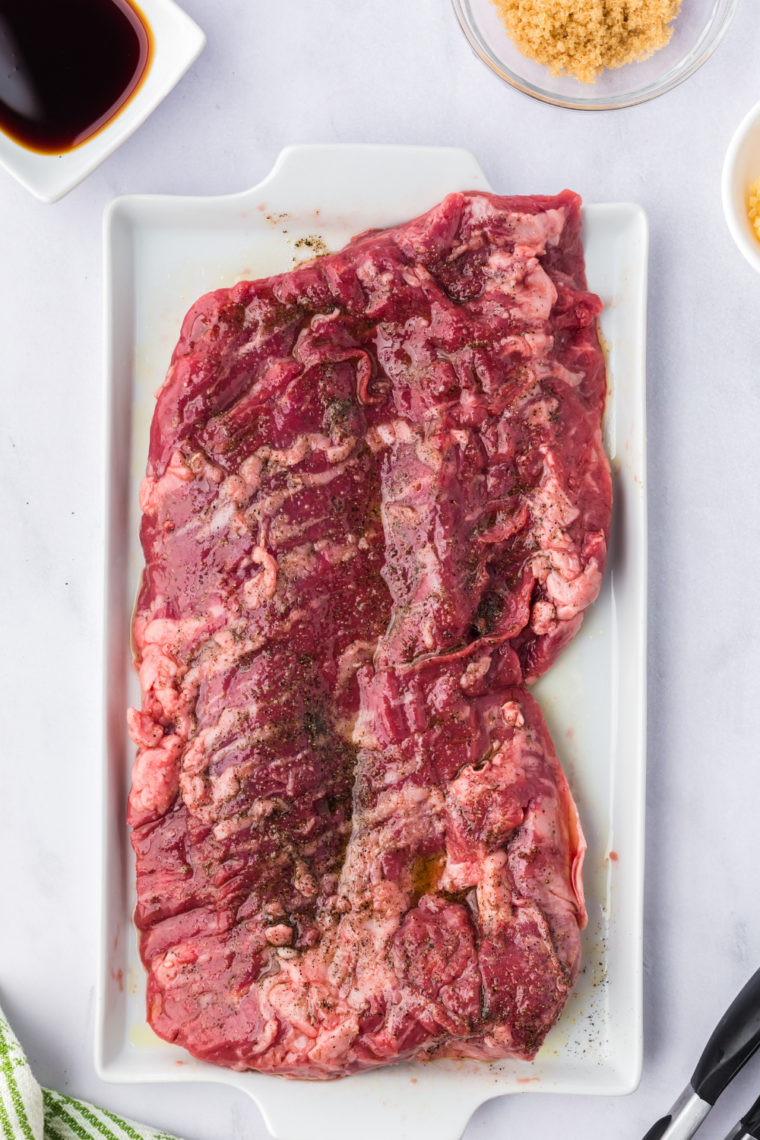 Patting skirt steak dry with paper towels to remove moisture before searing