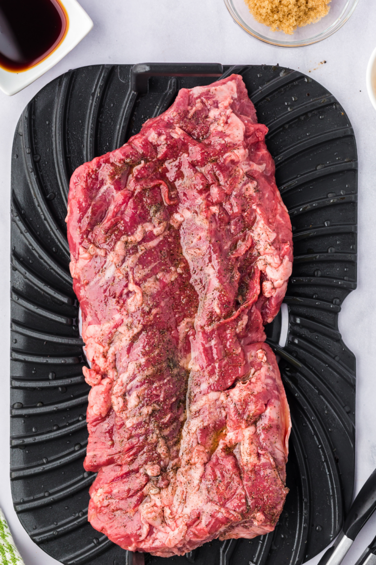 Searing skirt steak in hot pan until golden brown crust forms