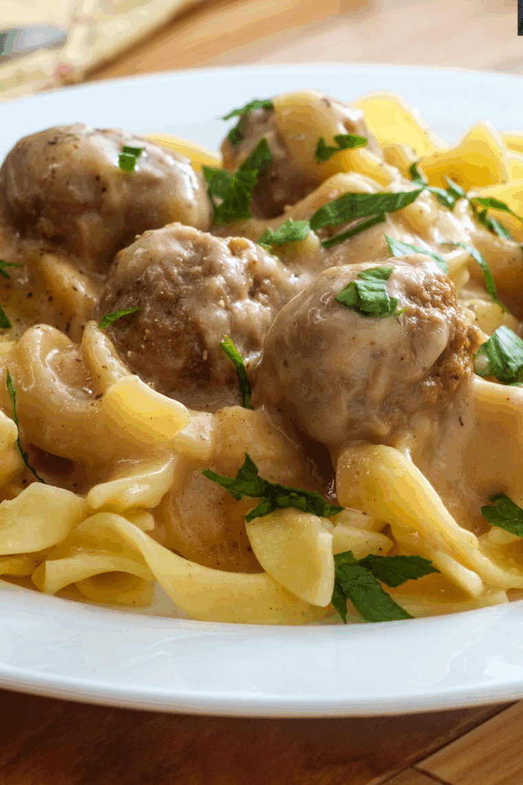 Instant Pot frozen meatballs served over creamy egg noodles with savory sauce