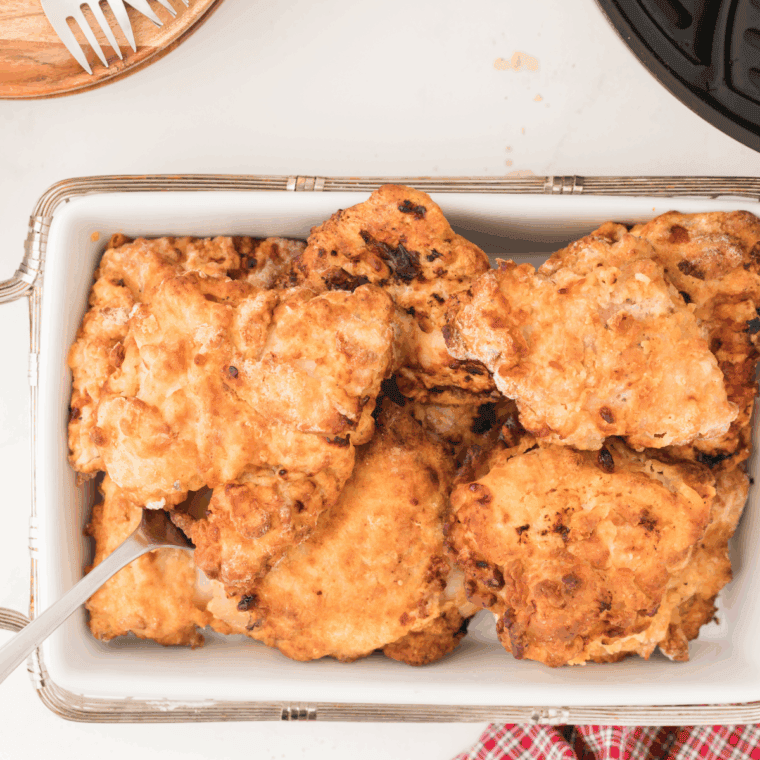 Basket of Easy Pioneer Woman Chicken Fried Chicken Recipe on kitchen table.
