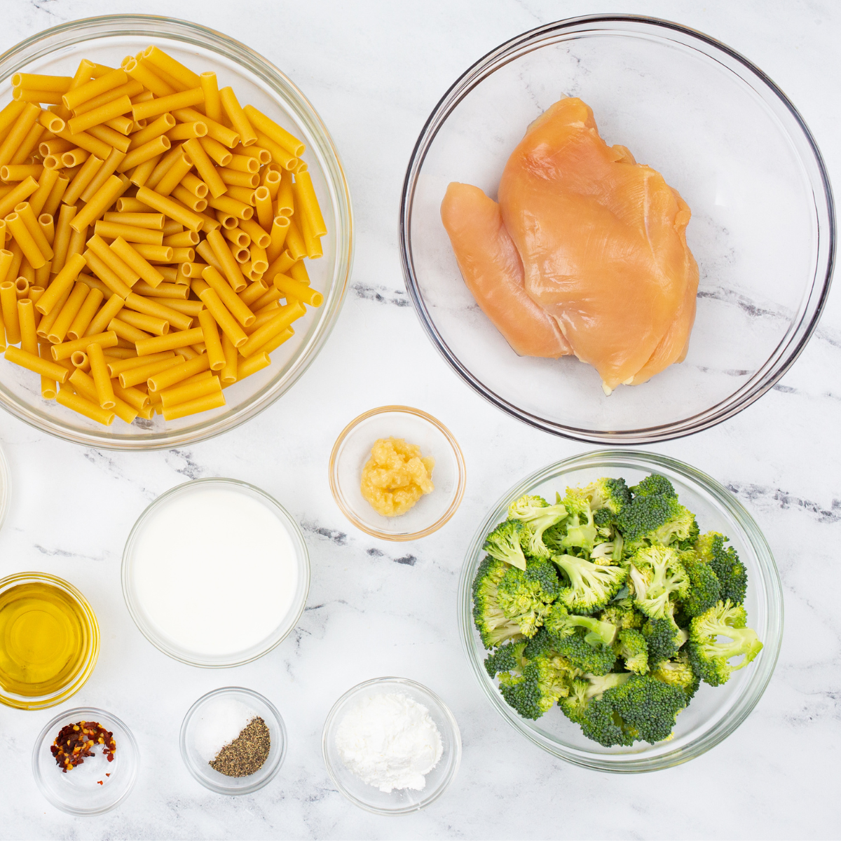 Ingredients needed for Air Fryer Broccoli Cheese Stuffed Chicken on kitchen table.