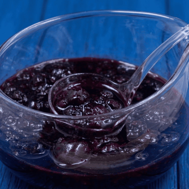 Jar of homemade Instant Pot Mixed Berry Jam made with strawberries, blueberries, and raspberries.