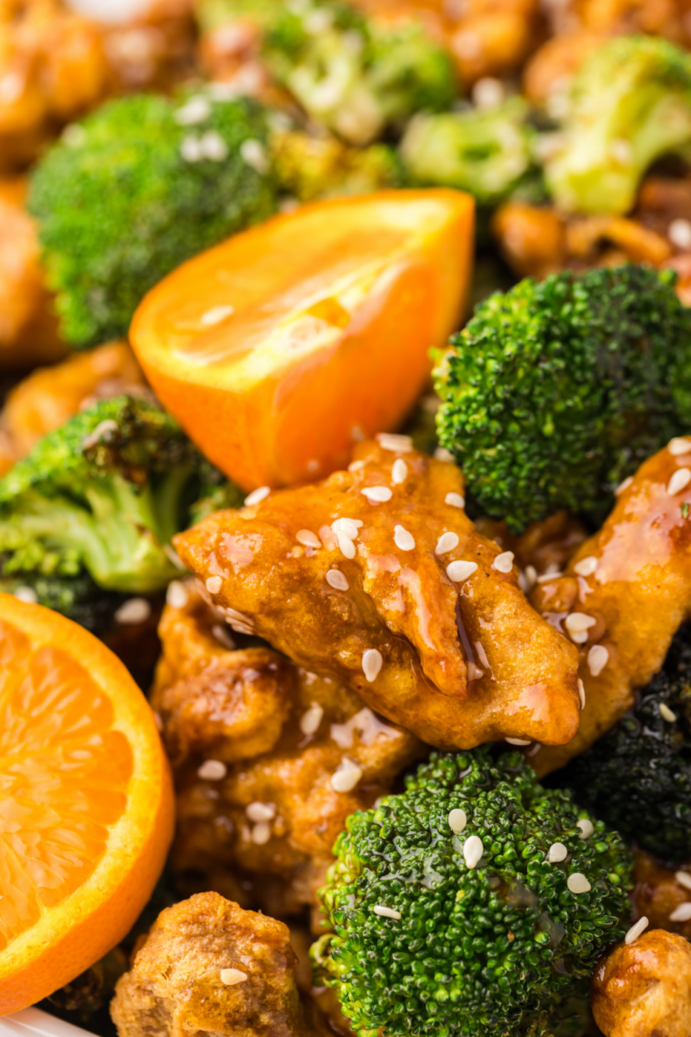 Crispy Ninja Crispi broccoli plated with a golden chicken breast for an easy weeknight dinner