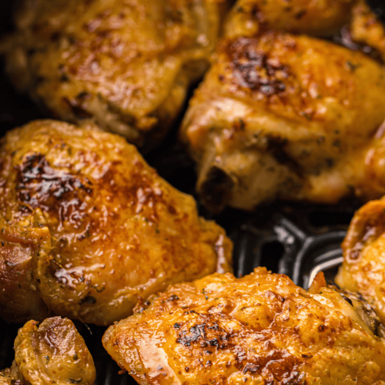 Smoky Air Fryer Chicken Thighs served on a plate, crispy on the outside, juicy on the inside.