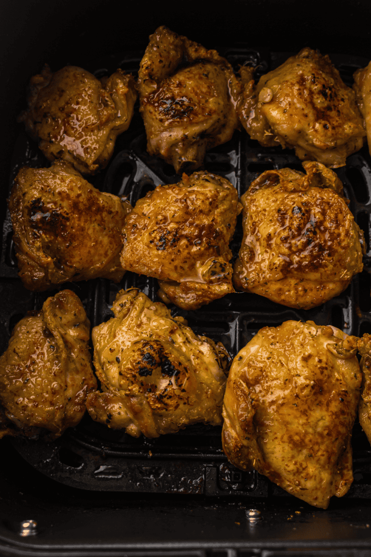 Air frying chicken thighs at 380°F, flipping halfway through, until crispy and cooked through.