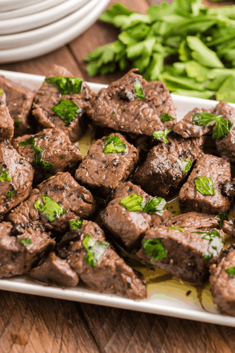 Texas Roadhouse Sirloin Beef Tips served with garlic butter and herbs.