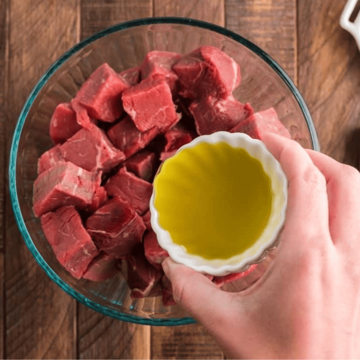 Add the melted butter and seasoning to the steak bites.