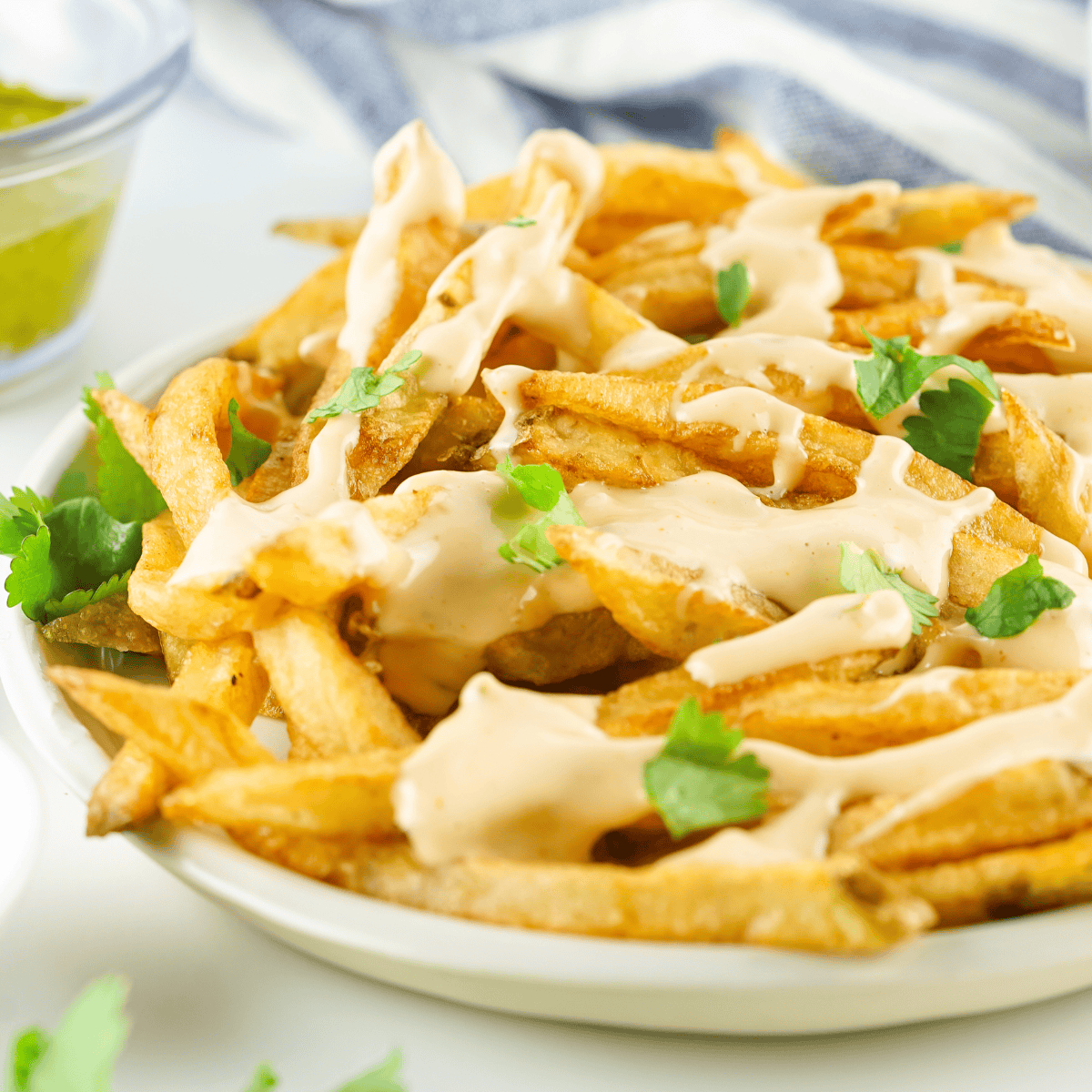 In-N-Out Animal Style Fries copycat topped with melted cheese, grilled onions, and spread over golden crispy fries.