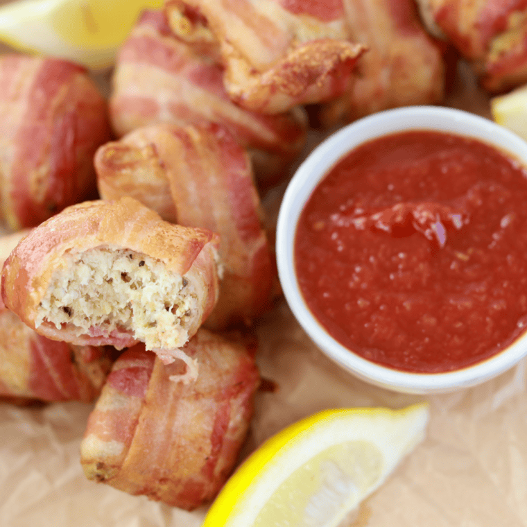 Golden air fryer bacon-wrapped crab rolls served on a plate, crispy and ready to eat