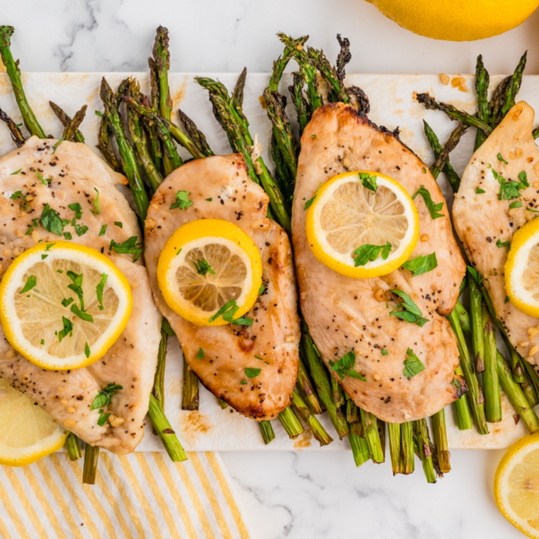 Deliciously plated Air Fryer Chicken and Asparagus, showcasing juicy chicken breasts and vibrant green asparagus spears.