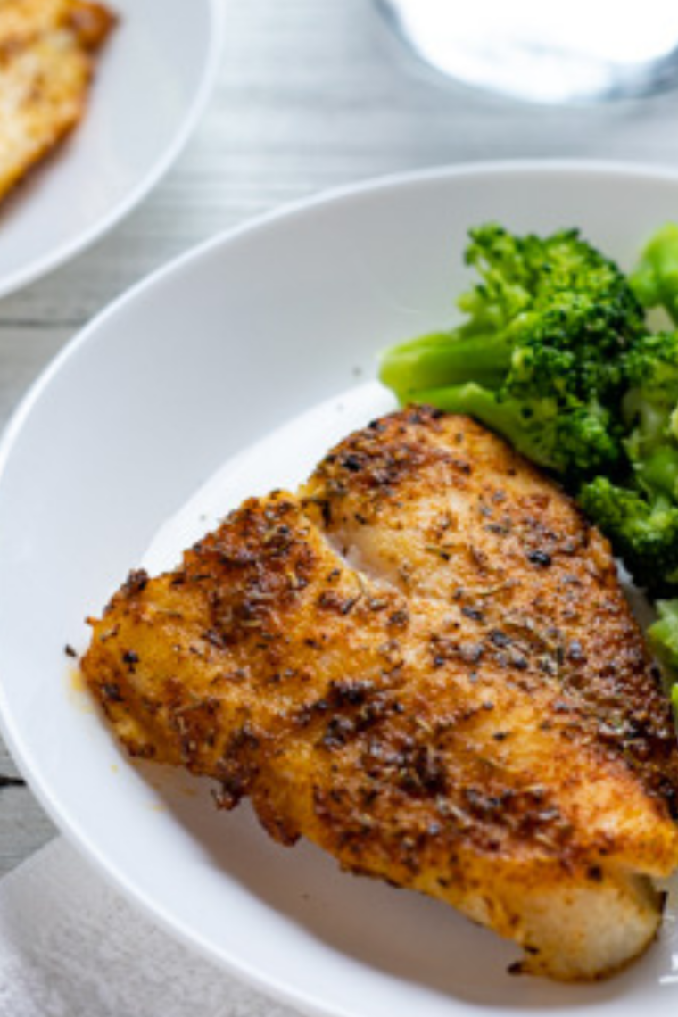 air fryer chilean sea bass with lemon garlic butter flaky tender fish on plate