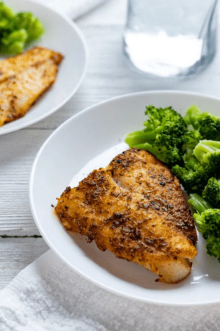 air fryer chilean sea bass with lemon garlic butter flaky tender fish on plate