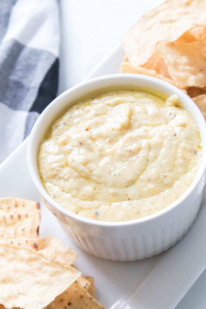 "Bowl of creamy white cheddar beer cheese sauce with soft pretzels for dipping."