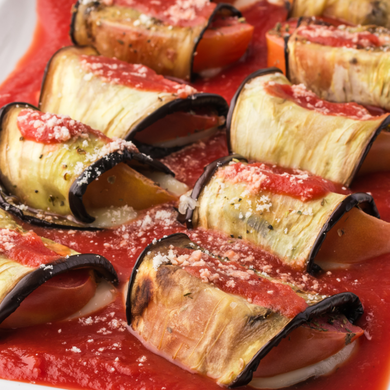 Plate of crispy and cheesy Air Fryer Eggplant Rollatini with mozzarella, tomato, and basil.