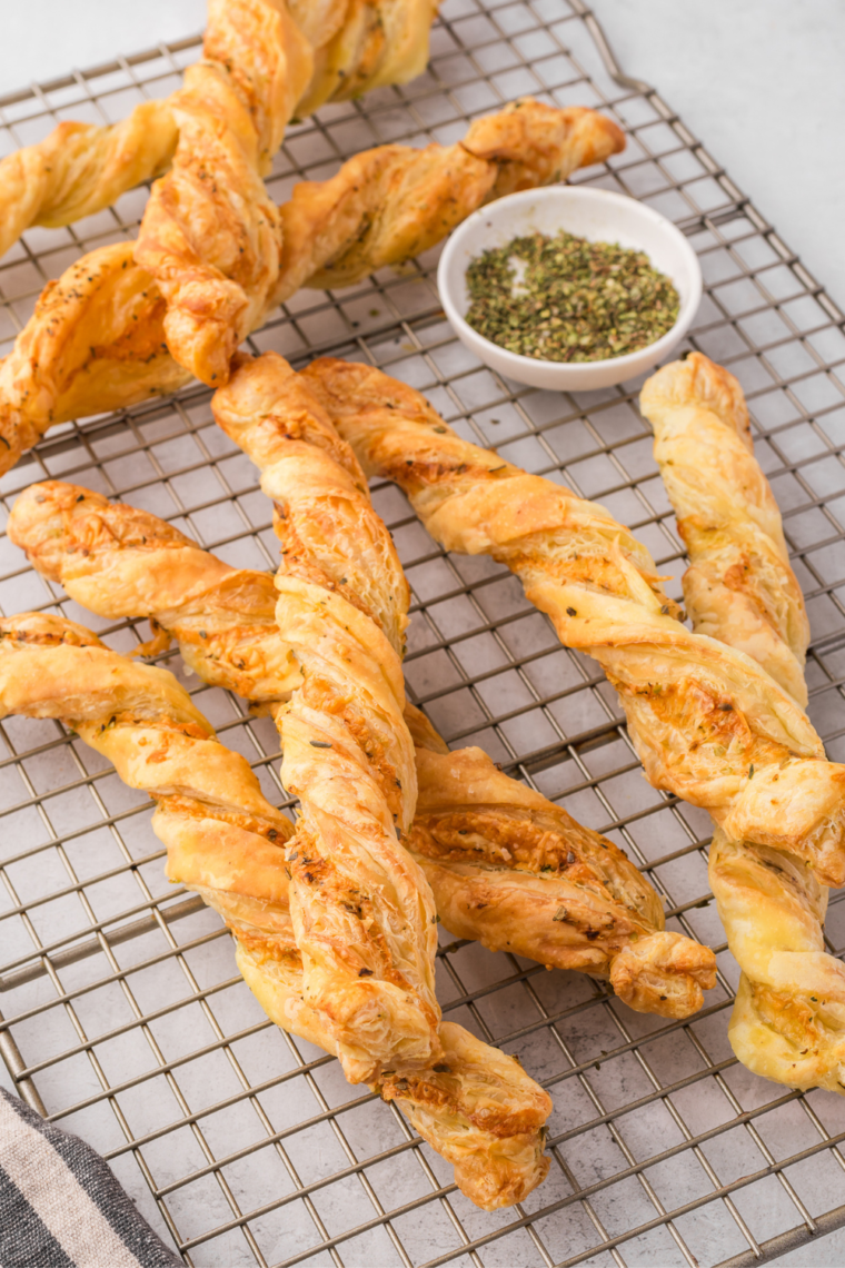 Golden, flaky Air Fryer Ham and Cheese Twists with melted cheese and ham, served on a plate.