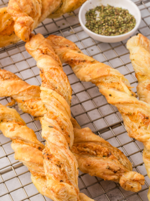 Golden, crispy Air Fryer Ham and Cheese Twists with melted cheese and ham peeking out, served on a plate.