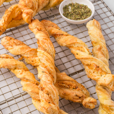 Golden, crispy Air Fryer Ham and Cheese Twists with melted cheese and ham peeking out, served on a plate.